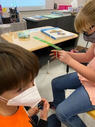 Two grade four students designing and learning how a fixed pulley works.