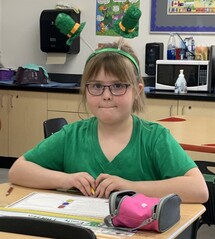 Grade two student working at her desk.