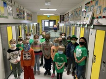 Grade two students posing in front of the web of strings.